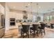 Bright kitchen featuring a large island with barstool seating, pendant lighting, and stainless-steel appliances at 3434 Boleo Ct, Las Vegas, NV 89141