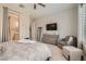 Comfortable main bedroom featuring a TV, plantation shutters, full-length mirror, and seating at 3434 Boleo Ct, Las Vegas, NV 89141