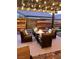 Cozy backyard with a fire pit, seating, paver patio, pergola and ambient lighting creating a warm atmosphere at 3434 Boleo Ct, Las Vegas, NV 89141