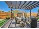 Charming outdoor patio with a pergola, comfortable seating, a stone water feature, and lush landscaping at 3434 Boleo Ct, Las Vegas, NV 89141