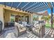 Relaxing outdoor space with a pergola-covered patio, comfortable seating, and an outdoor dining area at 3434 Boleo Ct, Las Vegas, NV 89141