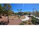 Community playground with slide, swing set, and mature shade trees at 3434 Boleo Ct, Las Vegas, NV 89141