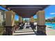 Inviting pool-side pergola with lounge seating offers a resort-like experience at 3434 Boleo Ct, Las Vegas, NV 89141