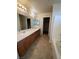 This bathroom features a double vanity, tile flooring, and a shower/tub combo at 3748 Autumn King Ave, Henderson, NV 89052