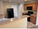 Functional kitchen featuring a black refrigerator, wooden cabinets, and a breakfast bar at 3748 Autumn King Ave, Henderson, NV 89052