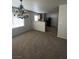 Spacious living room with carpeted floors, leading into the kitchen area at 3748 Autumn King Ave, Henderson, NV 89052