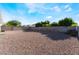 Wide angle of backyard showing the gravel yard, block wall and plenty of open space ready for desert landscaping at 3839 Dusty Glen Ct, North Las Vegas, NV 89032