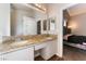 Bathroom featuring double granite sinks and view to bedroom at 3839 Dusty Glen Ct, North Las Vegas, NV 89032