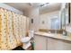 Functional bathroom with a bee-themed shower curtain, granite countertop, and modern fixtures at 3839 Dusty Glen Ct, North Las Vegas, NV 89032