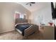 Bedroom with carpet, ceiling fan, mounted television and natural light at 3839 Dusty Glen Ct, North Las Vegas, NV 89032