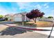 Lovely single-story home with a two-car garage, desert landscaping, and a beautiful leafy tree at 3839 Dusty Glen Ct, North Las Vegas, NV 89032