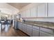 Spacious kitchen with stainless steel refrigerator, granite countertop and wooden floors at 3839 Dusty Glen Ct, North Las Vegas, NV 89032