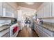 Bright kitchen with granite counters, appliances, wood floors and view into the living and dining areas at 3839 Dusty Glen Ct, North Las Vegas, NV 89032