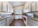 Bright kitchen features granite countertops, white cabinets, and wood floors at 3839 Dusty Glen Ct, North Las Vegas, NV 89032