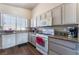 Galley kitchen with granite counters, tile backsplash, and white appliances at 3839 Dusty Glen Ct, North Las Vegas, NV 89032