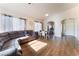 Open-concept living and dining area with wood floors, neutral colors, and bright natural light at 3839 Dusty Glen Ct, North Las Vegas, NV 89032