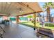 A covered patio area features a pool, trampoline, and lush greenery, creating an ideal outdoor retreat at 4406 Parkchester Cir, Las Vegas, NV 89108