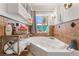 A jetted tub sits beneath a window with natural light, complemented by stylish fixtures and cabinetry at 4406 Parkchester Cir, Las Vegas, NV 89108