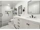 Modern bathroom featuring double vanity, a sleek walk-in shower with black trim, and a neutral color palette at 4406 Parkchester Cir, Las Vegas, NV 89108