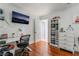 Bright bedroom features hardwood floors, a sleek desk, and a mounted television for added comfort at 4406 Parkchester Cir, Las Vegas, NV 89108
