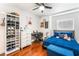 Comfortable bedroom with hardwood floors, bright natural light, a ceiling fan, and minimalist decor at 4406 Parkchester Cir, Las Vegas, NV 89108