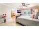 Spacious bedroom boasts tile floors, a ceiling fan, a view of the pool, and an en-suite bathroom at 4406 Parkchester Cir, Las Vegas, NV 89108