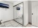 Bedroom features a mirrored closet, TV, tile floors, and white walls at 4406 Parkchester Cir, Las Vegas, NV 89108