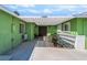 Green home featuring a covered patio area with dark wood doors and a white pergola at 4406 Parkchester Cir, Las Vegas, NV 89108