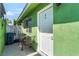 Exterior side view of the home with a small patio and table at 4406 Parkchester Cir, Las Vegas, NV 89108