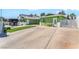 Charming green home featuring a spacious driveway and secured by a white horizontal slat fence at 4406 Parkchester Cir, Las Vegas, NV 89108