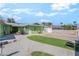 Green home featuring a spacious driveway with artificial grass and a basketball hoop at 4406 Parkchester Cir, Las Vegas, NV 89108