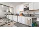 This bright kitchen offers white cabinets, granite counters, and modern appliances with a dining counter at 4406 Parkchester Cir, Las Vegas, NV 89108