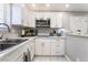 Bright kitchen featuring white cabinets, stainless steel appliances, and ample countertop space at 4406 Parkchester Cir, Las Vegas, NV 89108