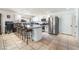 Well-lit kitchen features white cabinetry, stainless steel appliances, and breakfast bar seating at 4406 Parkchester Cir, Las Vegas, NV 89108