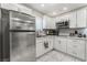Modern kitchen with stainless steel refrigerator, microwave and white cabinetry at 4406 Parkchester Cir, Las Vegas, NV 89108