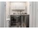Efficient laundry room with modern washer and dryer units and overhead storage at 4406 Parkchester Cir, Las Vegas, NV 89108