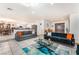 Spacious open-concept living area with tile flooring, comfortable sofas and stylish decor at 4406 Parkchester Cir, Las Vegas, NV 89108
