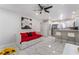 Open-concept living area with modern kitchen, a daybed, and bright, tile flooring at 4406 Parkchester Cir, Las Vegas, NV 89108