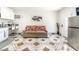 Open-concept living space with kitchenette, sofa, and white door, providing a comfortable and efficient layout at 4406 Parkchester Cir, Las Vegas, NV 89108