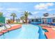 Outdoor pool area with landscaped privacy fence, patio, outdoor kitchen, and lounge chairs at 4406 Parkchester Cir, Las Vegas, NV 89108