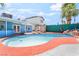 Inviting pool area with patio seating and green privacy wall, perfect for outdoor relaxation and entertainment at 4406 Parkchester Cir, Las Vegas, NV 89108