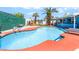 View of the beautiful blue swimming pool surrounded by a lush green privacy fence at 4406 Parkchester Cir, Las Vegas, NV 89108