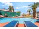 A blue swimming pool is surrounded by privacy landscaping and palm trees at 4406 Parkchester Cir, Las Vegas, NV 89108