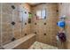 This shower features a built-in bench and tiled walls with a handheld shower head and tile flooring at 4406 Parkchester Cir, Las Vegas, NV 89108
