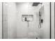 This renovated walk-in shower features modern fixtures, a built-in niche, and sleek design at 4406 Parkchester Cir, Las Vegas, NV 89108