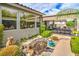 Landscaped backyard featuring a tranquil pond, covered patio, and lush greenery at 4419 Via Bianca Ave, Las Vegas, NV 89141