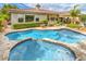 Inviting backyard pool and spa with lush landscaping surrounding the patio at 4419 Via Bianca Ave, Las Vegas, NV 89141
