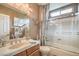Bathroom with a vanity sink with a bath tub and glass shower door at 4419 Via Bianca Ave, Las Vegas, NV 89141