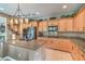 Spacious kitchen with granite countertops, stainless steel appliances, island, and custom wood cabinetry at 4419 Via Bianca Ave, Las Vegas, NV 89141