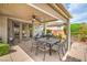 Inviting covered patio with an outdoor dining set, perfect for entertaining or relaxing at 4419 Via Bianca Ave, Las Vegas, NV 89141